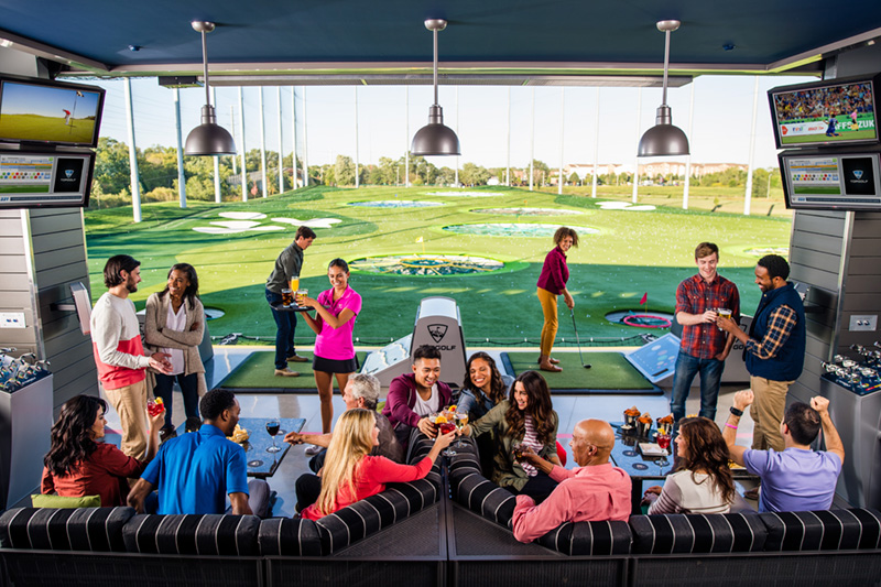 people socializing at topgolf