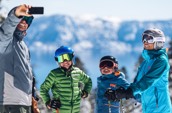 family taking selfie snowboarding